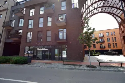 a tall brick building with a bench in front of it at Vilnius Old Town in Vilnius