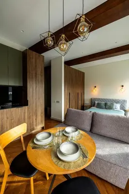 a living room with a table and a couch at Studio Nemuno 27 in Kaunas