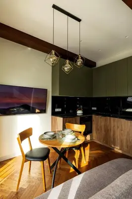 a kitchen with a table and chairs in a room at Studio Nemuno 27 in Kaunas