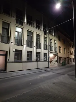an empty street with a building at night at Studio Nemuno 27 in Kaunas