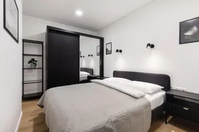 a bedroom with a bed and a large mirror at Hook Studios Vilnius Old Town in Vilnius