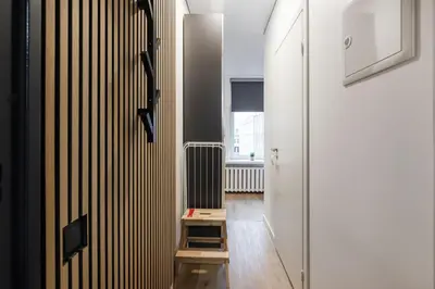 a hallway with a radiator and a wooden table at Hook Studios Vilnius Old Town in Vilnius