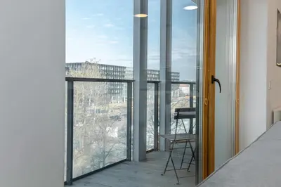 a glass balcony with a view of a building at Apartment with balcony and castle view by URBAN RENT in Vilnius