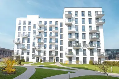 a large white apartment building with a pathway in front at Apartment with balcony and castle view by URBAN RENT in Vilnius