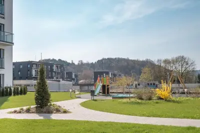 a park with a playground and a slide at Apartment with balcony and castle view by URBAN RENT in Vilnius