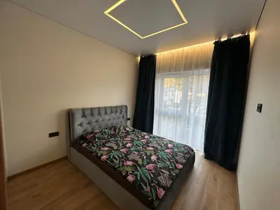 a bedroom with a bed in front of a window at Jaukus butas 2 kambariu girioje in Kaunas