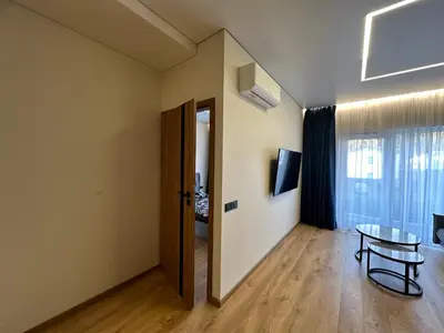 a room with a door and a table and a window at Jaukus butas 2 kambariu girioje in Kaunas