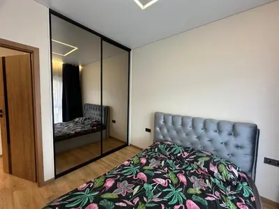 a bedroom with a bed and a mirror at Jaukus butas 2 kambariu girioje in Kaunas