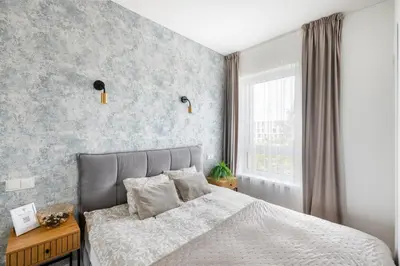a bedroom with a bed with a gray wall at Apartment in the center of Vilnius in Vilnius