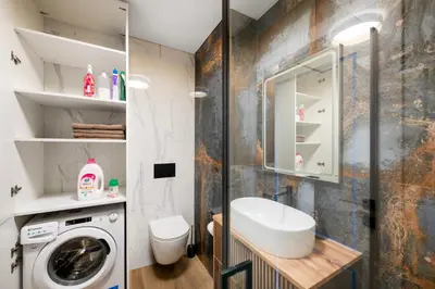 a bathroom with a sink and a washing machine at Apartment in the center of Vilnius in Vilnius