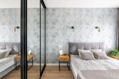 two beds in a bedroom with gray wallpaper at Apartment in the center of Vilnius in Vilnius