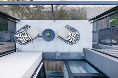 a balcony with two cushions and a glass table at Apartment in the center of Vilnius in Vilnius