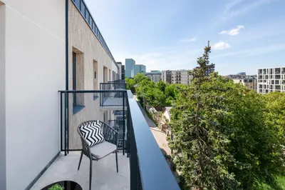 a balcony with a chair on a building at Apartment in the center of Vilnius in Vilnius