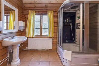 a bathroom with a shower and a sink at Sporto ir poilsio centras KORNEALITA IEVALAUKIS in Gaveikėnai