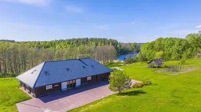 an overhead view of a house with a blue roof at Sporto ir poilsio centras KORNEALITA IEVALAUKIS in Gaveikėnai