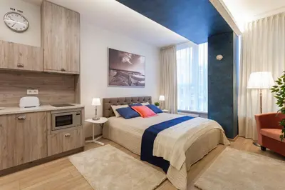 a bedroom with a bed and a large window at Raugyklos apartamentai in Vilnius