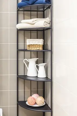 a black shelf in a bathroom with some donuts at Raugyklos apartamentai in Vilnius