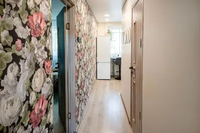 a hallway with a flowery wall in a kitchen at Urban Escape Kaunas - Quiet Apartment 5 km from City Center in Kaunas