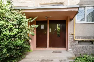 a entrance to a building with a brown door at Urban Escape Kaunas - Quiet Apartment 5 km from City Center in Kaunas