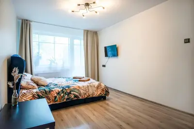 a bedroom with a bed and a window at Urban Escape Kaunas - Quiet Apartment 5 km from City Center in Kaunas
