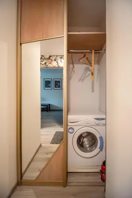 a laundry room with a washer and dryer at Urban Escape Kaunas - Quiet Apartment 5 km from City Center in Kaunas