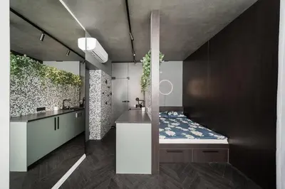a bathroom with a bed and a sink in it at Jaukus butas Kauno centre in Kaunas