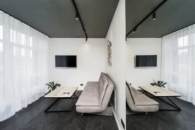 a dining room with two tables and two chairs at Jaukus butas Kauno centre in Kaunas