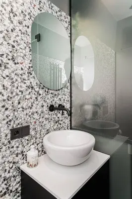 a bathroom with a white sink and a mirror at Jaukus butas Kauno centre in Kaunas