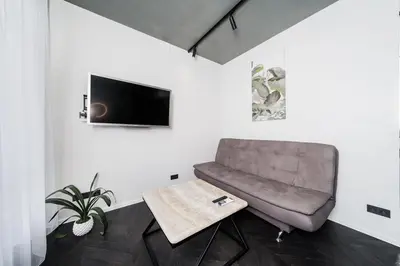 a living room with a couch and a table at Jaukus butas Kauno centre in Kaunas
