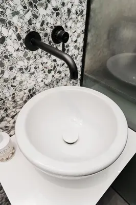 a white toilet in a bathroom with a sink at Jaukus butas Kauno centre in Kaunas