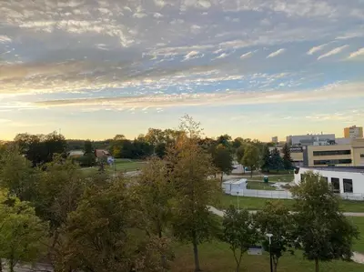 an overhead view of a park with trees and buildings at Cloud apartments in Alytus