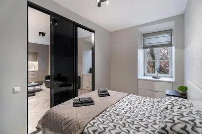 a bedroom with a large bed and a window at apartment with jacuzzi, old town in Vilnius