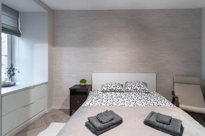 a bedroom with a bed with two pillows on it at apartment with jacuzzi, old town in Vilnius