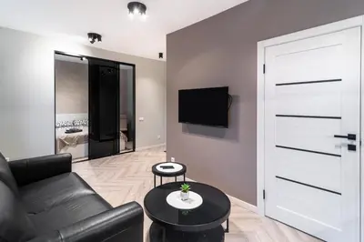 a living room with a couch and a tv at apartment with jacuzzi, old town in Vilnius