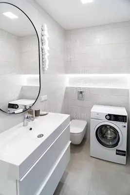 a bathroom with a washing machine and a washer at apartment with jacuzzi, old town in Vilnius