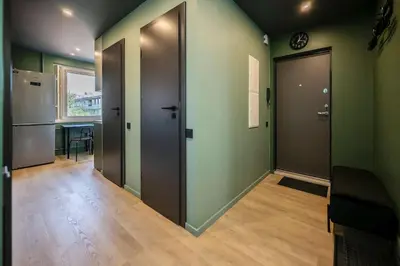 an empty hallway with two doors and a table at GoldenHugo Apartment in Vilnius