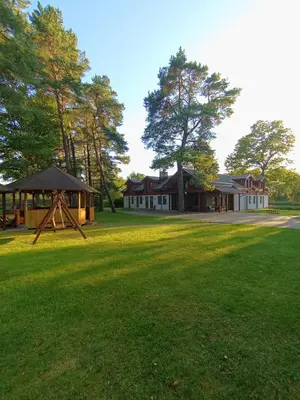 a large yard with a house and a gazebo at Sodyba Prie Tvenkinio in Kurtuvėnai