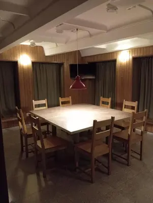 a large table and chairs in a room at Sodyba Prie Tvenkinio in Kurtuvėnai