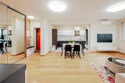 a kitchen and dining room with a table and chairs at Onas apartament 2 with private parking in Kaunas