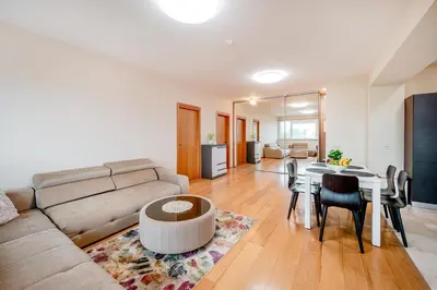 a living room with a couch and a table at Onas apartament 2 with private parking in Kaunas