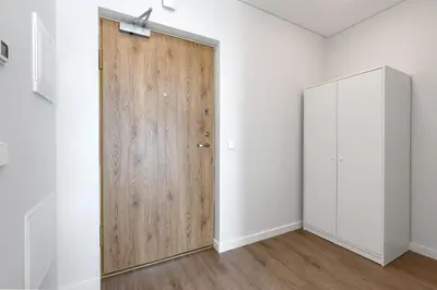 a wooden door in a room with white walls at Two room Apartment - self check-in in Vilnius