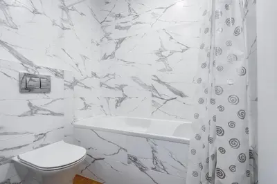 a white bathroom with a toilet and a shower curtain at Two room Apartment - self check-in in Vilnius