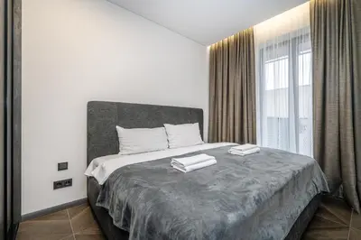 a bedroom with a large bed with two towels on it at Modern Oasis in Vilnius Center by Reside Baltic in Vilnius
