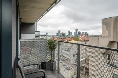 a balcony with chairs and a view of the city at Modern Oasis in Vilnius Center by Reside Baltic in Vilnius