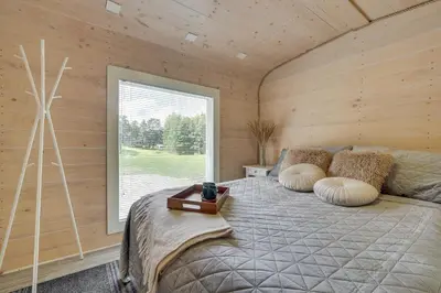a bedroom with a bed in a room with a window at Meldai in Pabradė