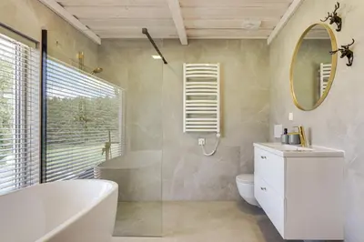 a bathroom with a tub and a toilet and a sink at Meldai in Pabradė