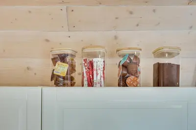 a row of glass jars sitting on top of a cabinet at Meldai in Pabradė