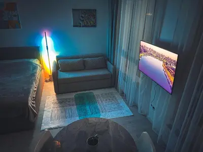 a living room with a couch and a table at Cozy Ozo apartments, free parking! in Vilnius