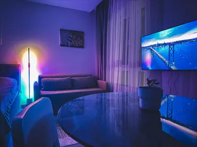 a living room with a table and a tv at Cozy Ozo apartments, free parking! in Vilnius