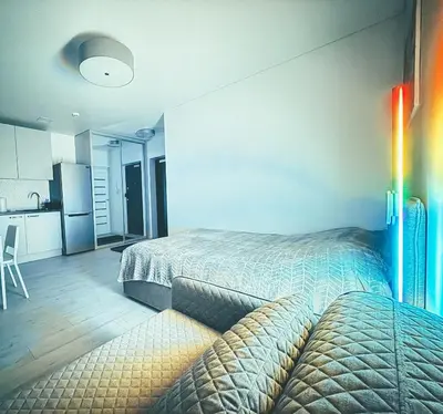 a room with two beds and a kitchen and a kitchen at Cozy Ozo apartments, free parking! in Vilnius